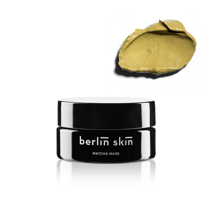 a black container with a black lid and a yellow paint spot